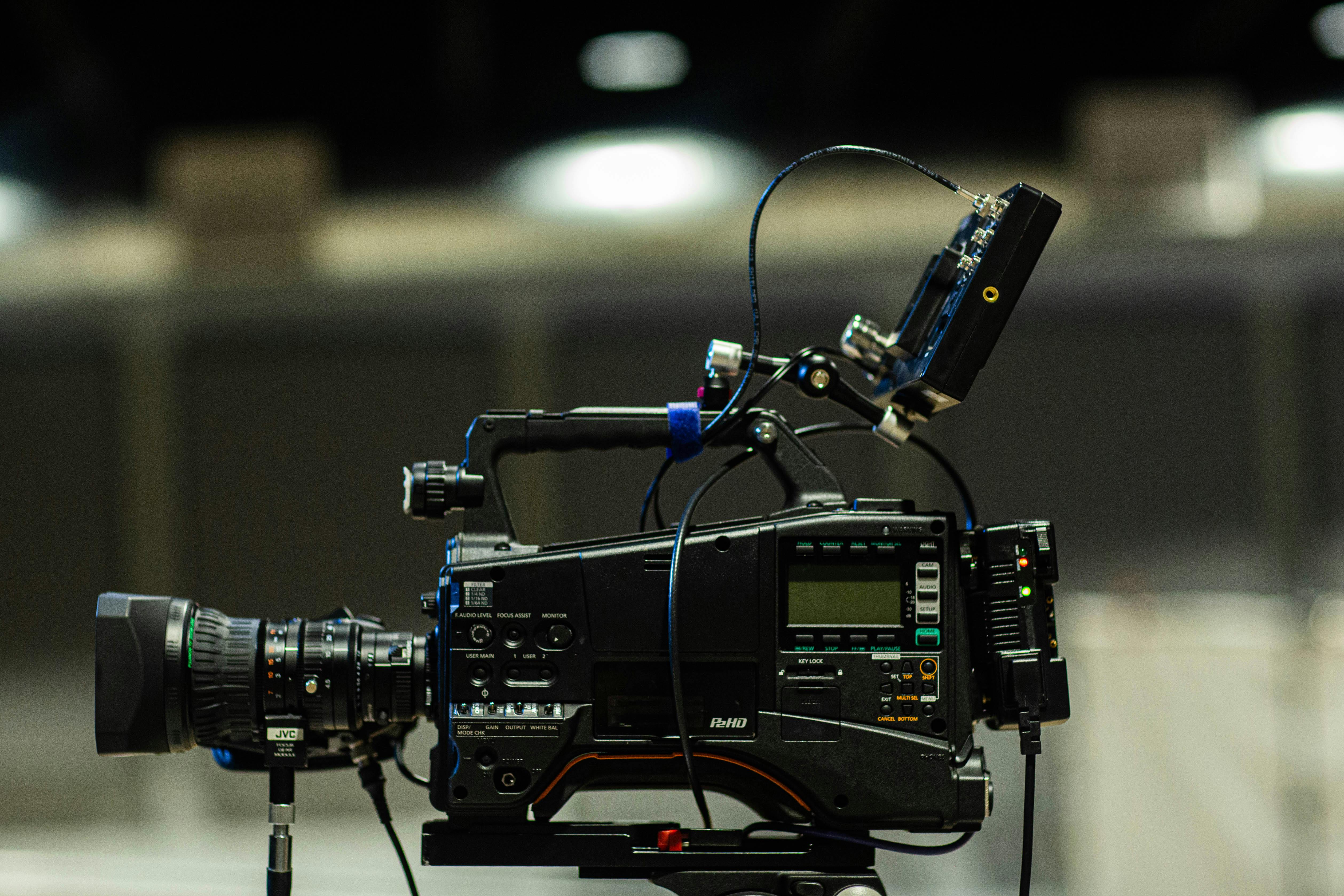 modern video camera under shiny lamps in studio