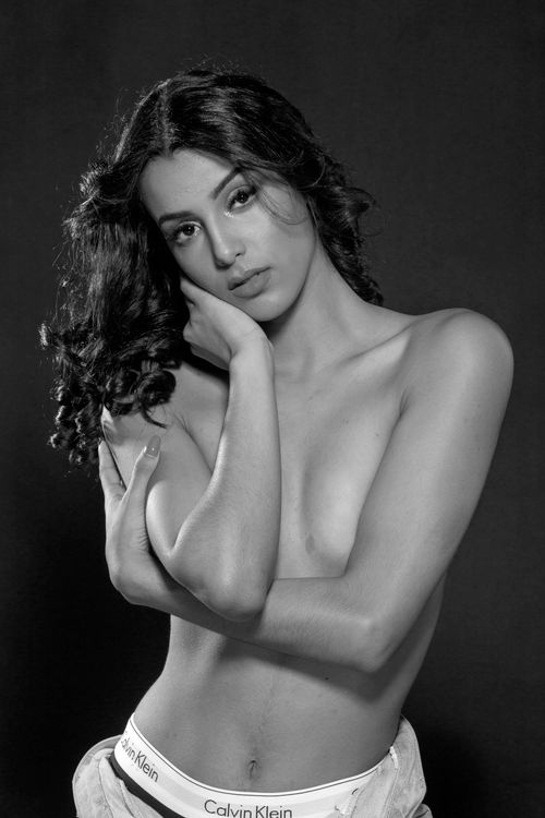 Free Striking monochrome portrait of a woman posing gracefully in a studio setting. Stock Photo
