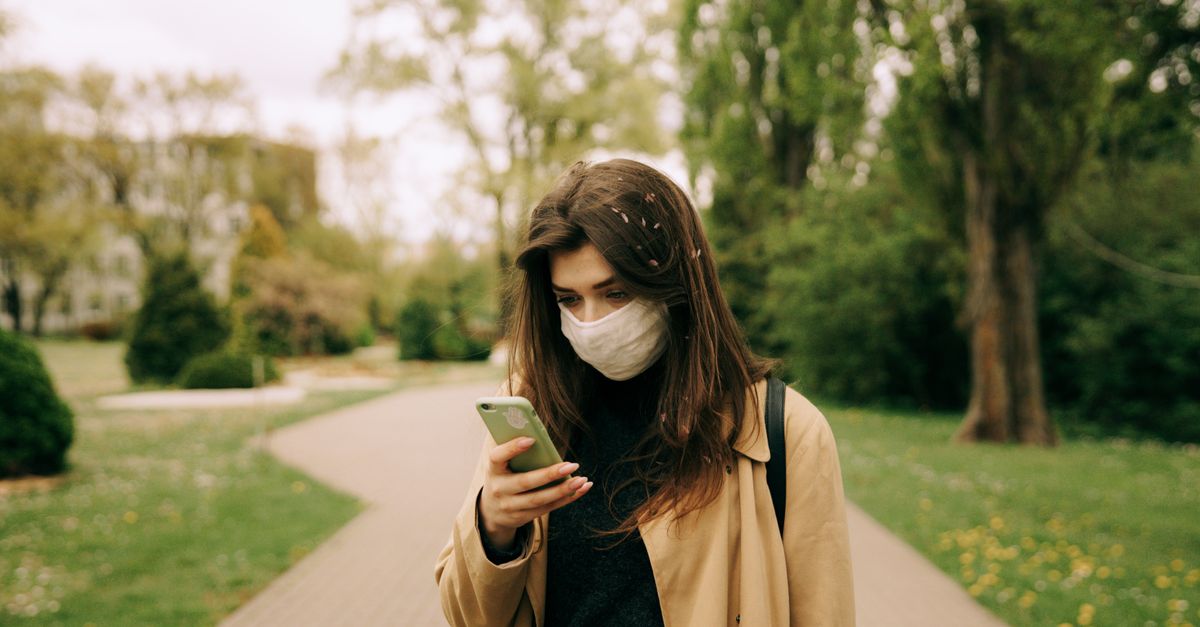 person walking slowly in park without phone, mindful living