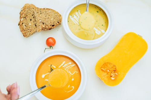 Sliced Bread With Yellow Soup on White Ceramic Plate