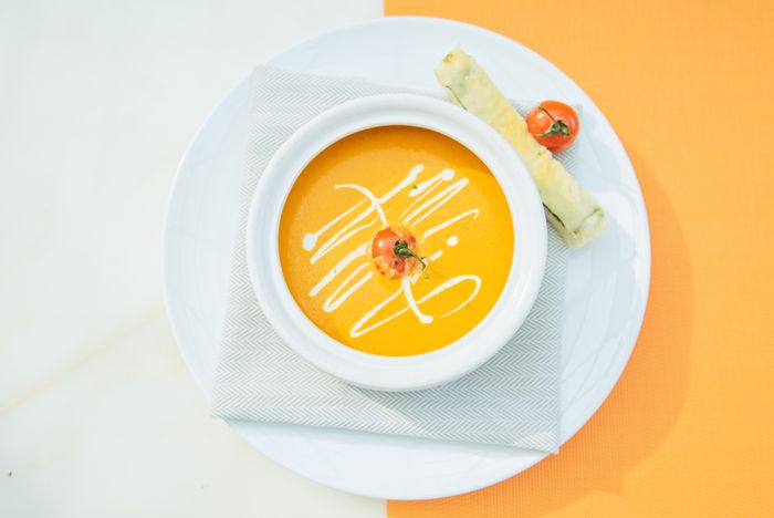 Roasted tomato soup with a breadstick — Denys Gromov on Pexels