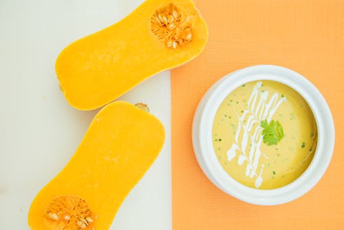 Sliced Pumpkin and Soup on White and Yellow Surface