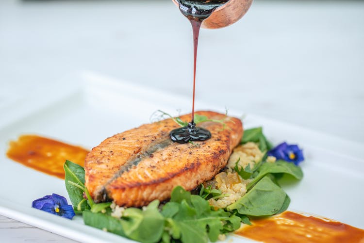 Black Sauce Pouring On Cooked Fish