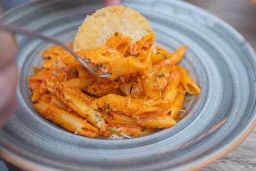 Orange Pasta Dish on Gray Ceramic Plate