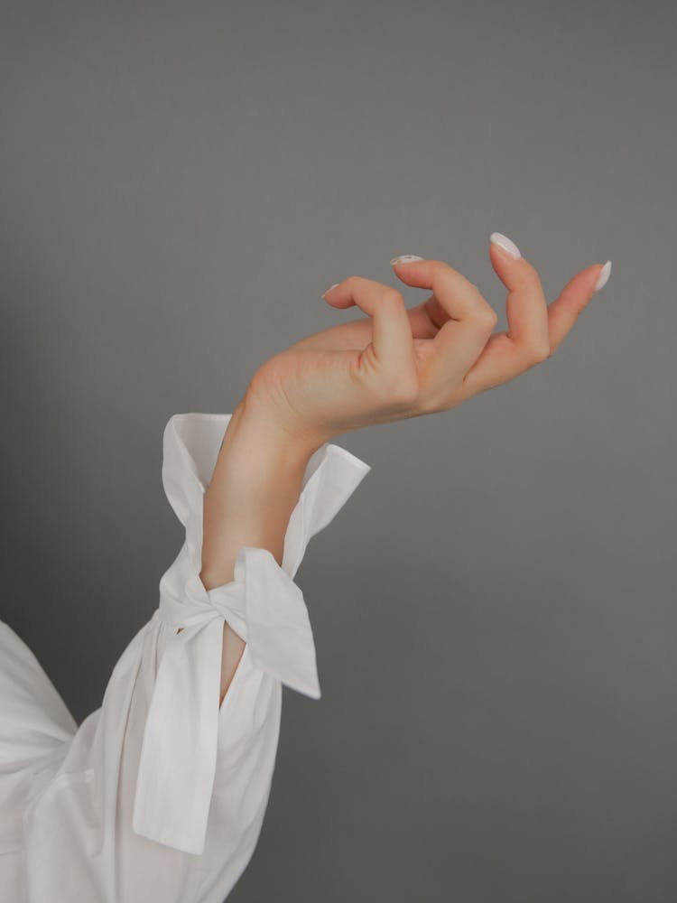 Photo Of A Person's Hand With White Long Sleeve