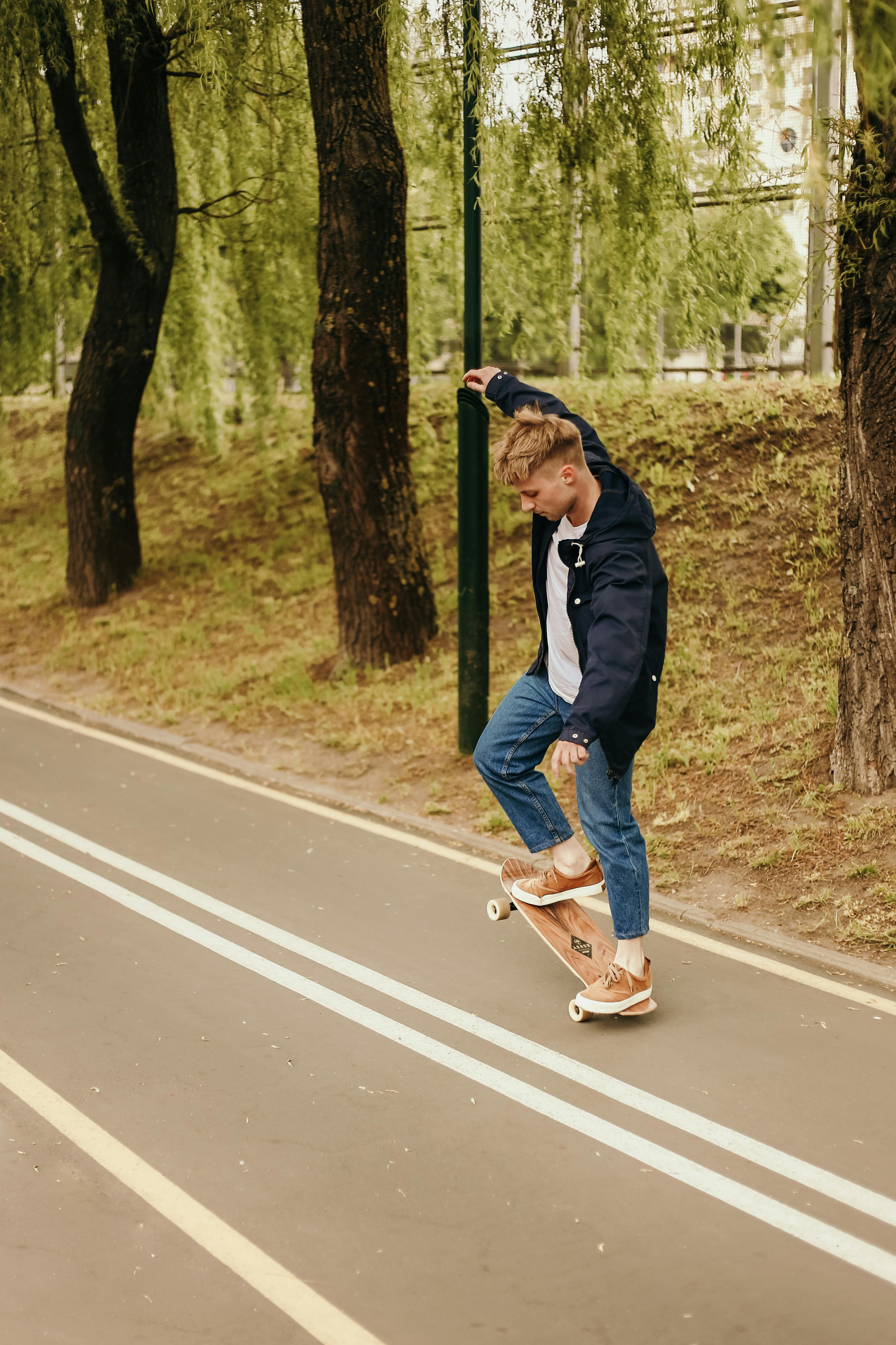 a man riding a skateboard on the concrete pavement