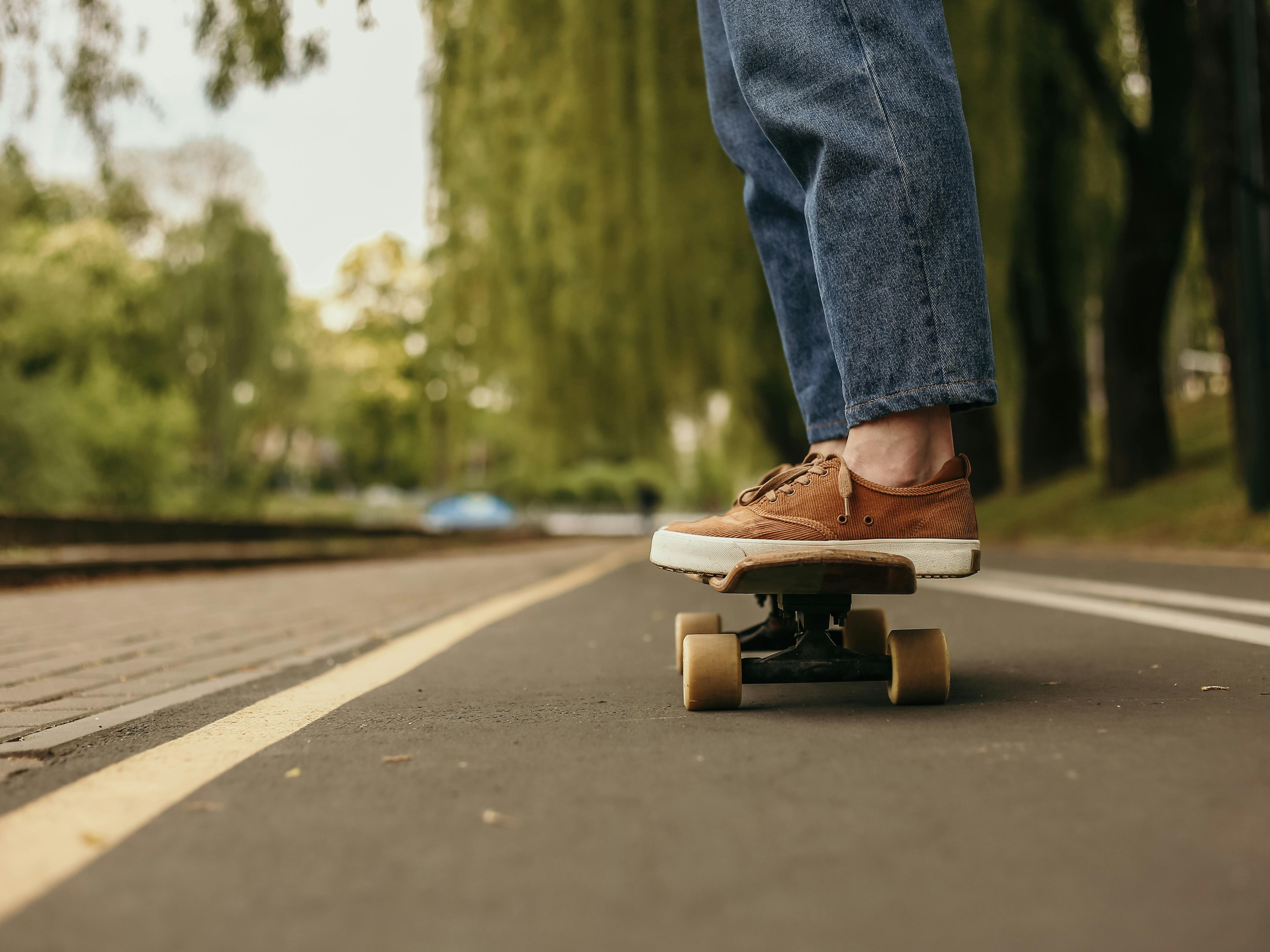 Sunlight over Legs of Person on Skateboard · Free Stock Photo