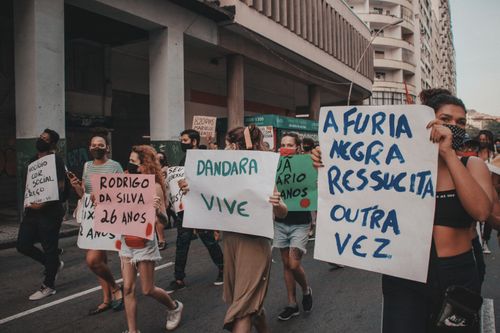 Free Protesters holding signs during a street march in Rio de Janeiro advocating for social justice. Stock Photo