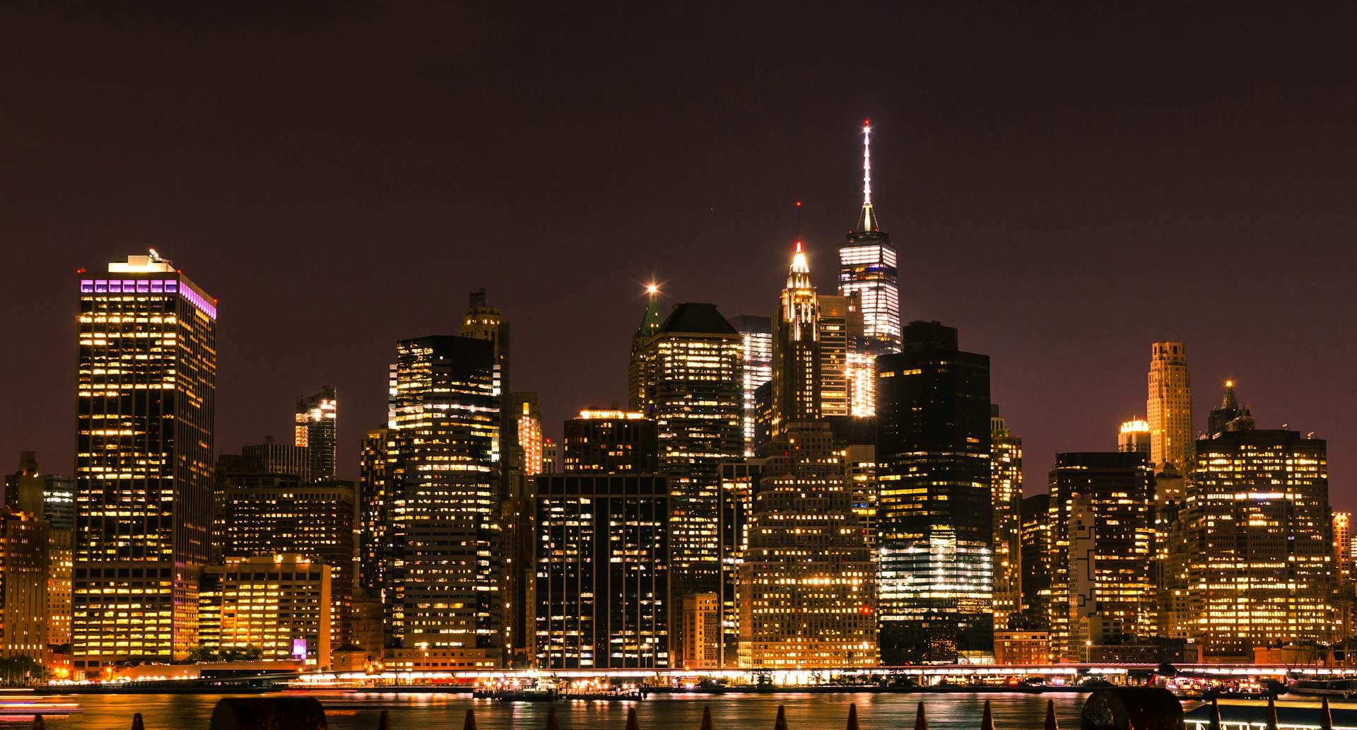 Illuminated New York City skyline at night showcasing iconic skyscrapers and city lights.