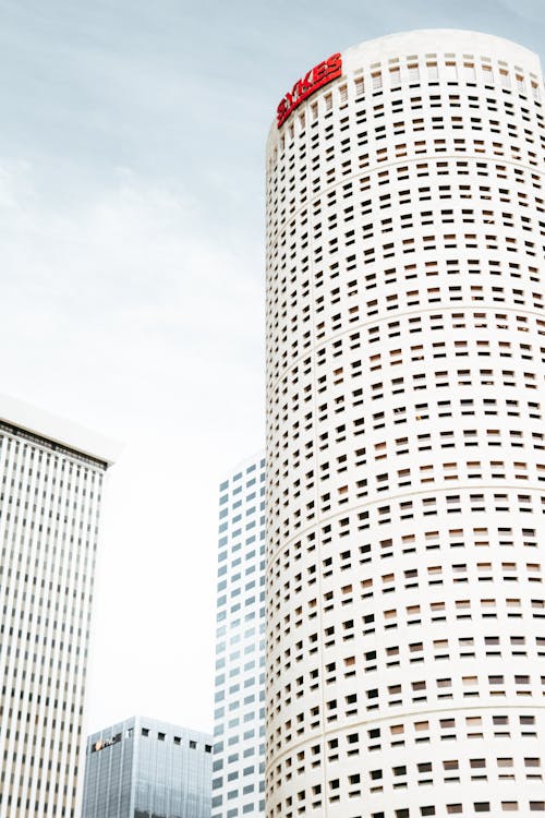 White Concrete Building Under White Clouds