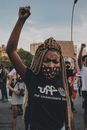 Person in Black and White Crew Neck T-shirt Raising His Hand