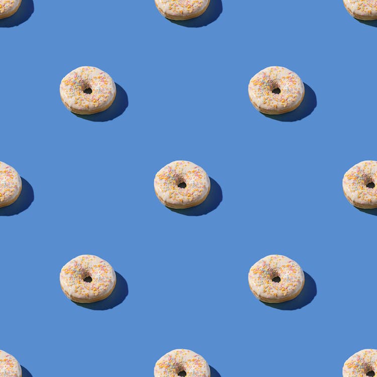 Doughnuts With Sprinkles On Blue Surface