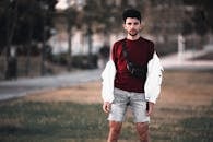 Shallow Focus Photo of Man in Red Shirt and Shorts