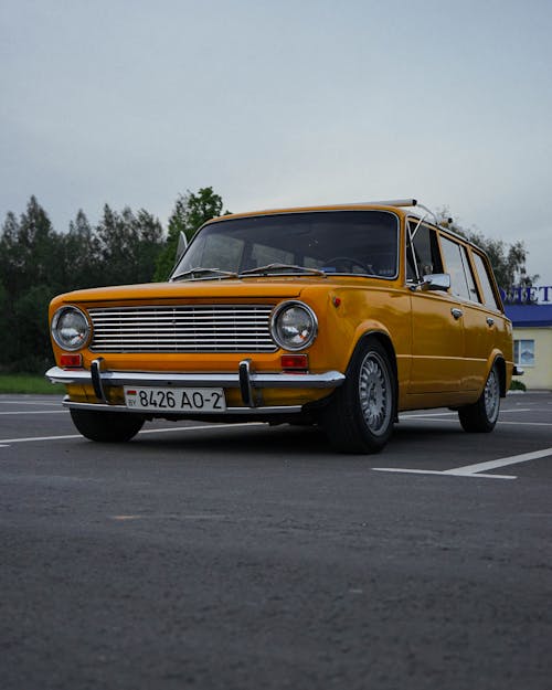 Yellow Vintage Car on Road