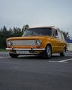 Yellow Vintage Car on Road