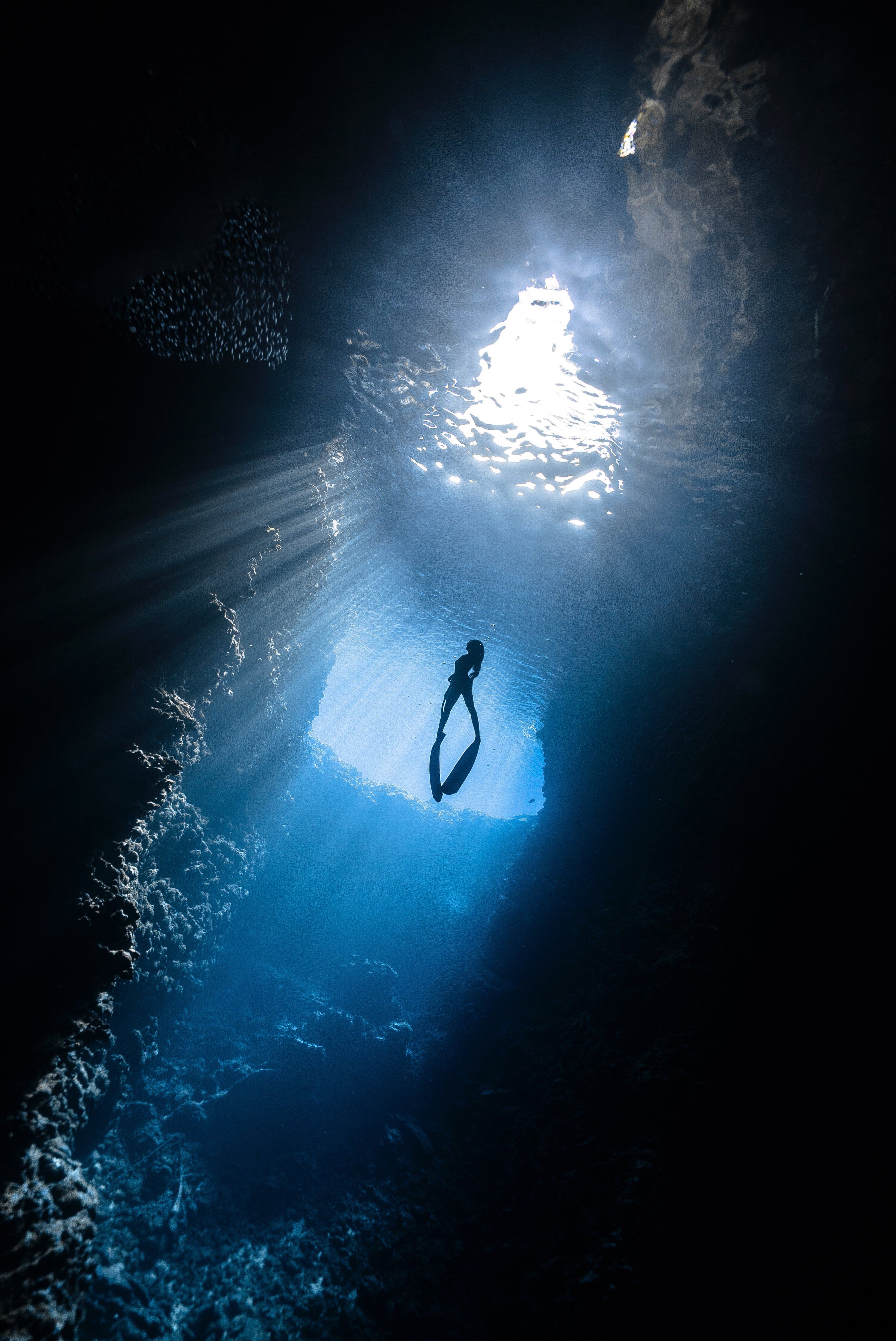 A diver in the light of a cave