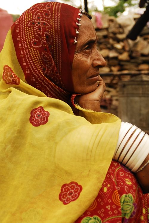 Free A senior Indian woman wearing colorful traditional clothing with a thoughtful expression. Stock Photo