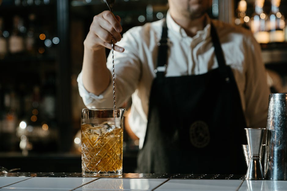 bartending tools and bib apron on bar counter - stylish bartending clothing