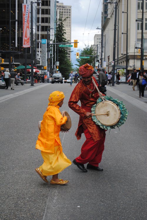 Man And Child Performing In The Street