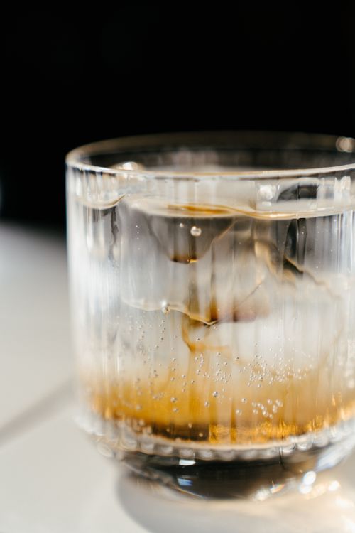 Free Close-up of a cold beverage with ice in a clear glass offering a refreshing visual. Stock Photo