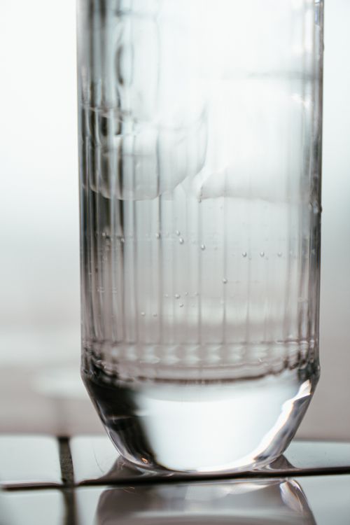 Free Refreshing close-up of ice cubes in a tall glass of water, highlighting clarity and chill. Stock Photo