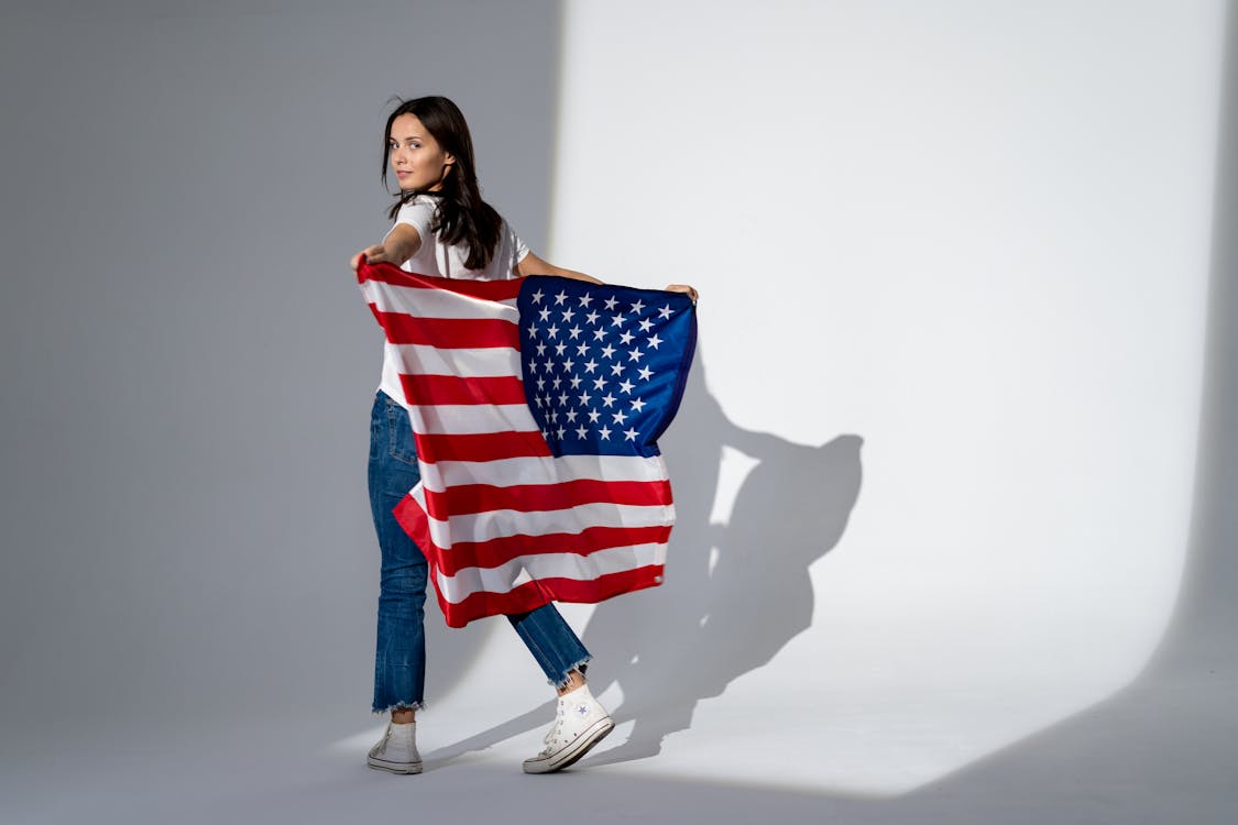 Free Woman Holding an American Flag Stock Photo