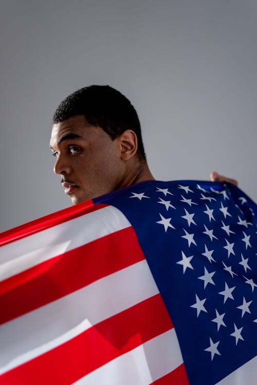 Free Man Holding an American Flag Stock Photo