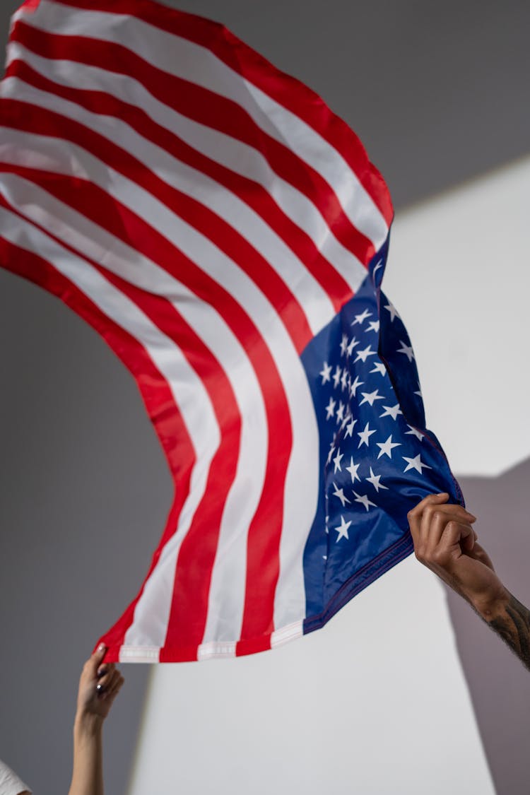 Hands Holding An American Flag