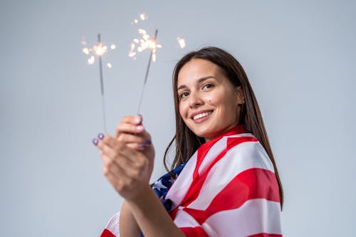 Smiling Woman Holding Sparklers