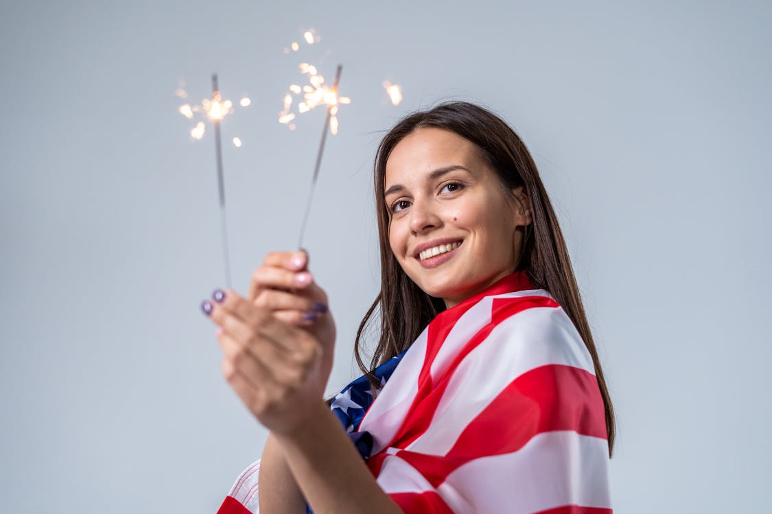 Free Smiling Woman Holding Sparklers Stock Photo