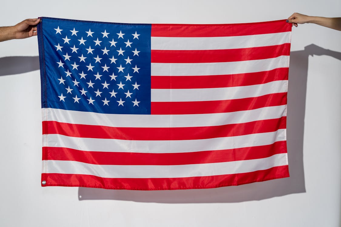 Free Hands Holding an American Flag Stock Photo
