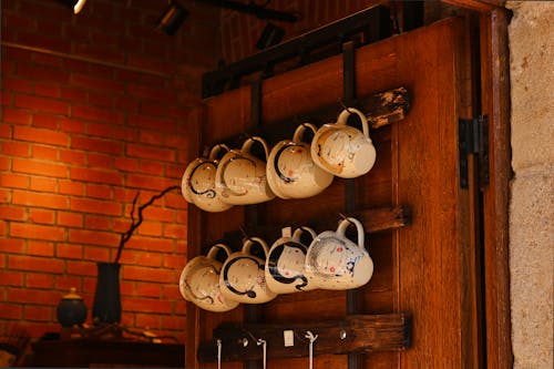 Photo Of Mugs Hanging On Wall 