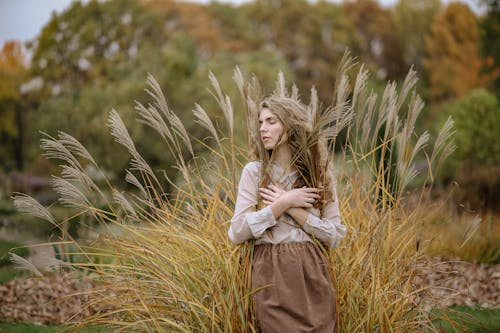 Photo Of Woman Standing On Wheat Field