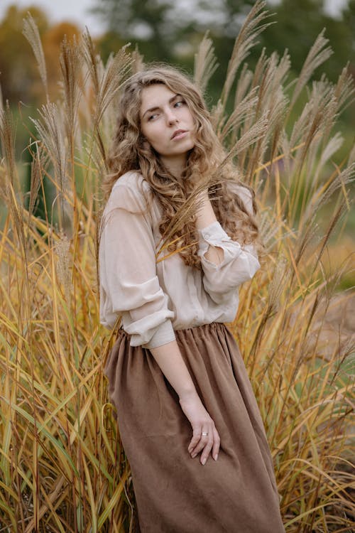 Photo Of Woman Standing Beside Wheat Leaves