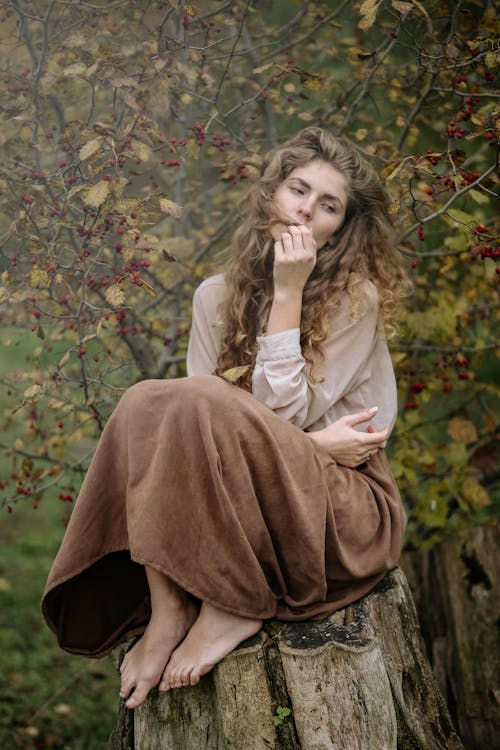 Free Photo Of Woman Sitting On Wood Stock Photo