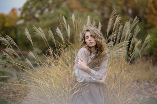 Free Photo Of Woman Standing On Wheat Field Stock Photo