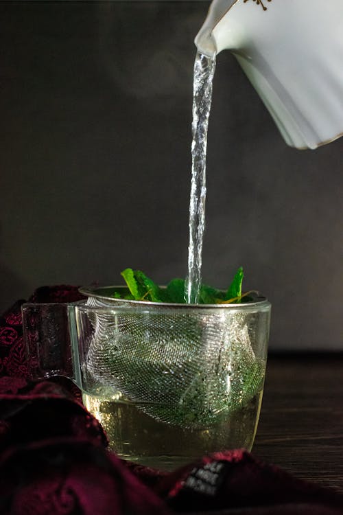 Free Water Poured To Green Leaves in Clear Glass  Stock Photo