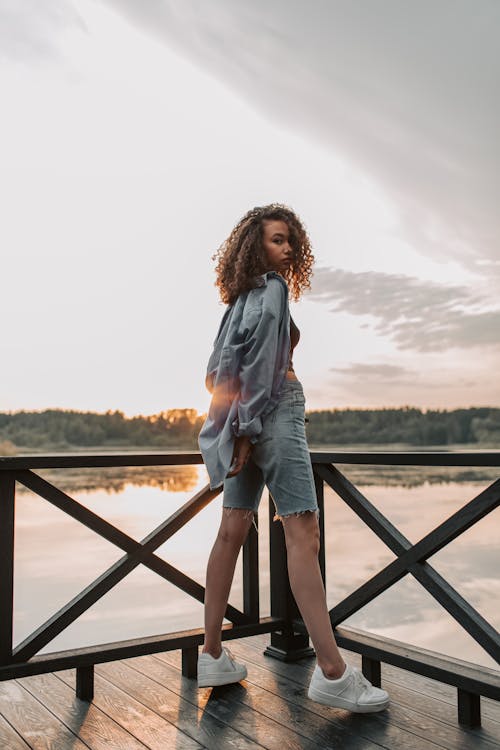 Photo Of Woman Standing On Wooden Dock 