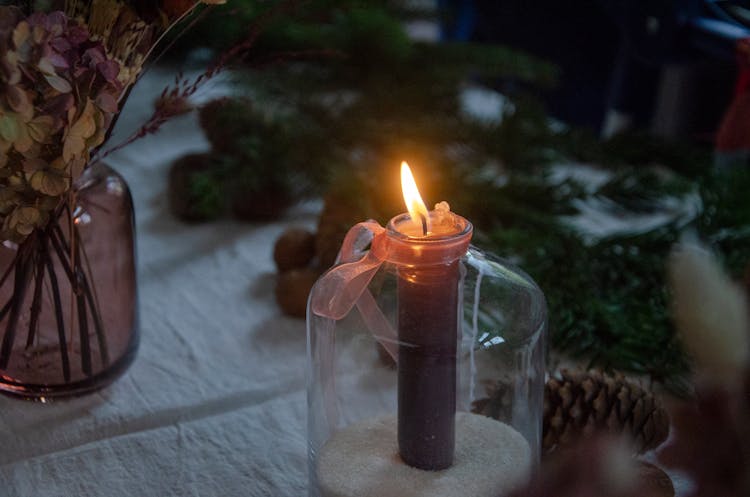 Lighted Red Candle In Clear Glass Holder