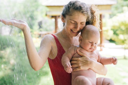 Free Photo Of Woman Carrying Baby Stock Photo