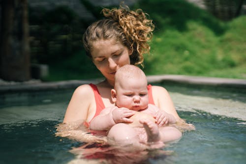 Photo Of Woman Holding Baby