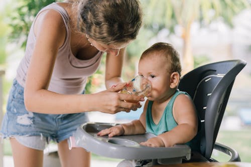 Free Photo Of Woman Assisting Baby Stock Photo