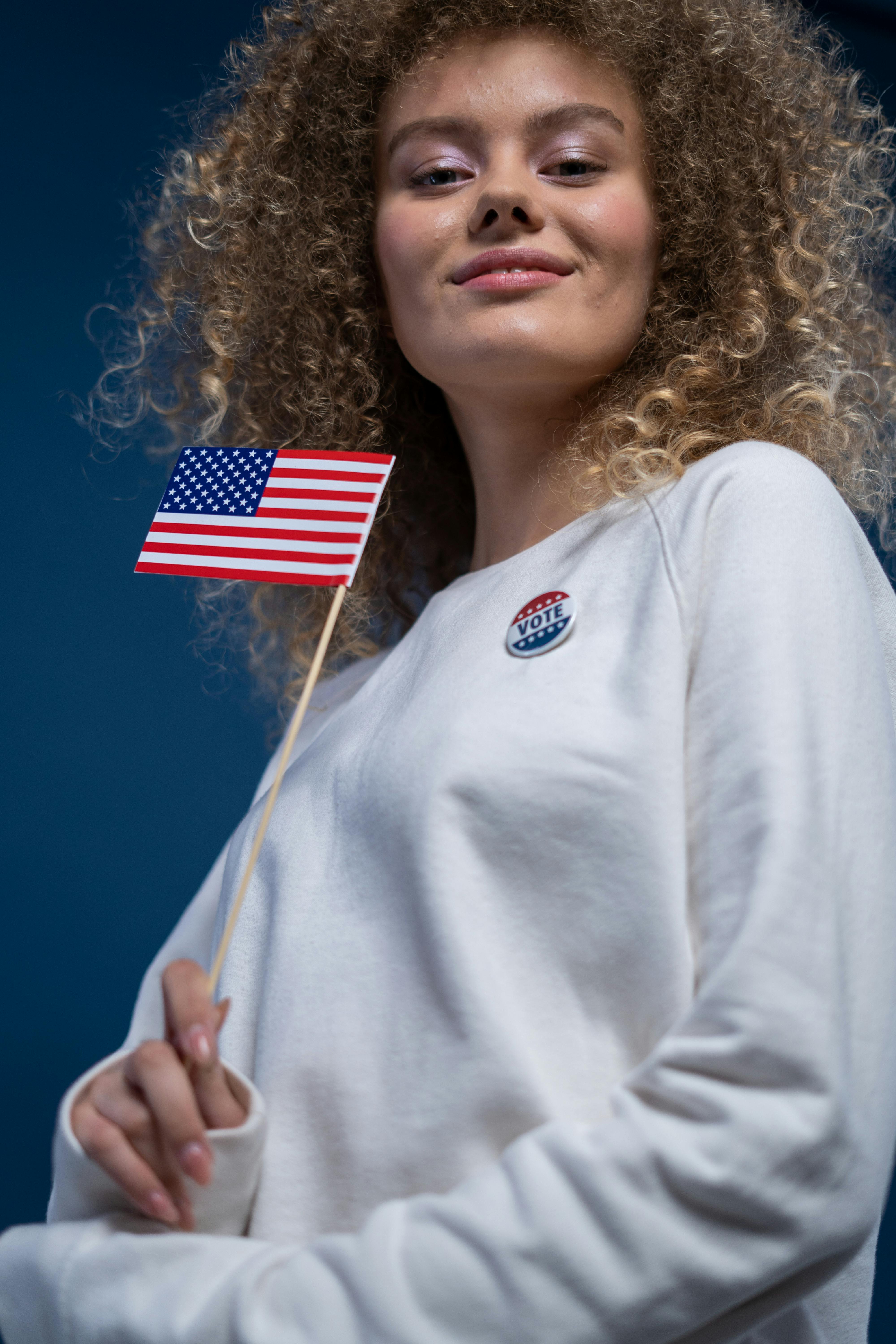 smiling woman holding an american flag