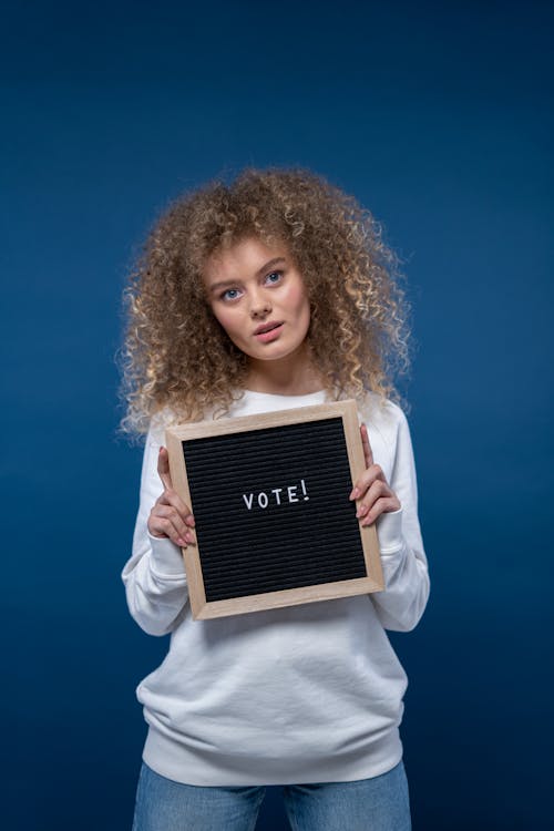 Woman Holding a Sign