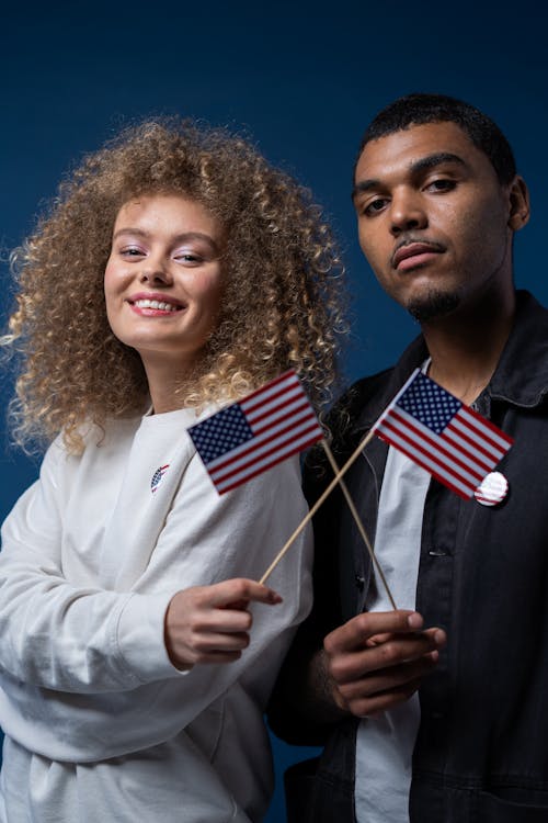 People Holding American Flags