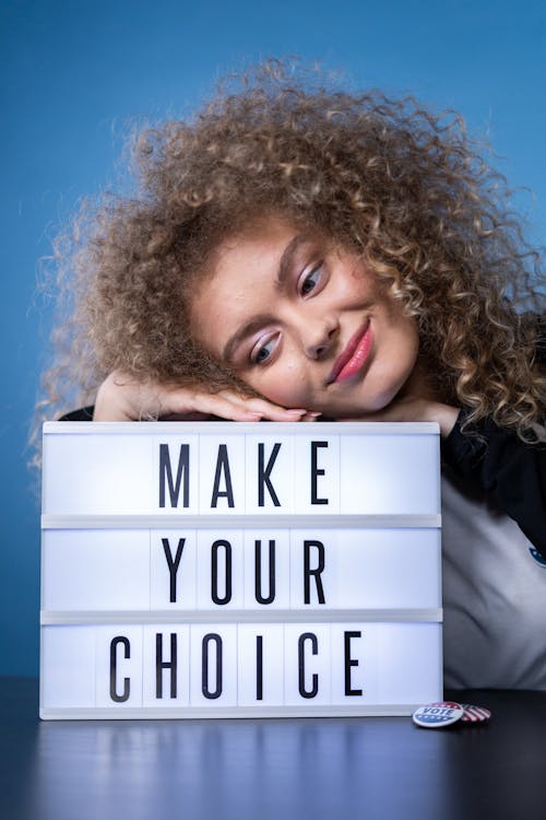 Free Smiling Woman With a Sign Stock Photo