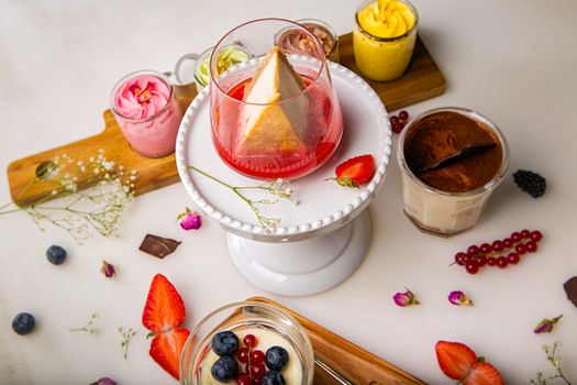 Delicious array of desserts featuring cheesecake and colorful berries on a white pedestal.