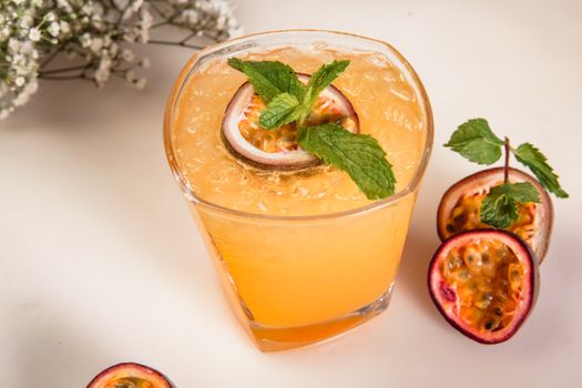 Close-up of a refreshing passion fruit beverage garnished with fresh mint leaves, perfect for a cool, delicious drink.