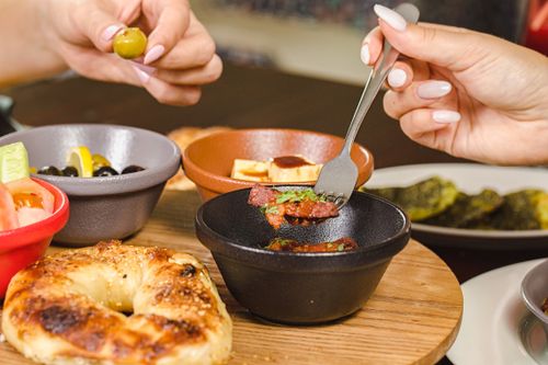 Free A delightful Middle Eastern breakfast spread featuring olives, bread, and various small dishes, showcasing vibrant flavors. Stock Photo