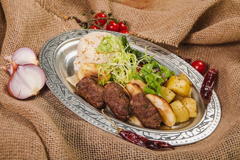 Grilled kebab platter with rice and vegetables — photo by Denys Gromov on Pexels